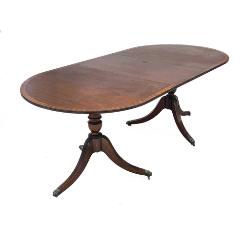 651 - A Regency style brass inlaid mahogany D-end dining table. The cross-banded edges with brass stringin... 