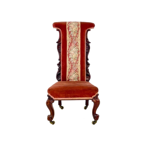 652 - A Victorian rosewood framed prie dieu chair. With carved side pieces, on cabriole front legs and bra... 