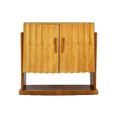 659 - An Art Deco demi lune maple cocktail cabinet. With fluted twin doors enclosing a single shallow shel... 