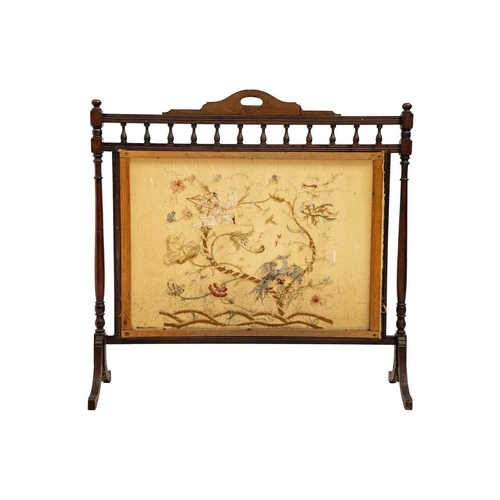 664 - An Edwardian walnut wide fire screen. The embroidered panel with two exotic birds, and foliage, heig... 