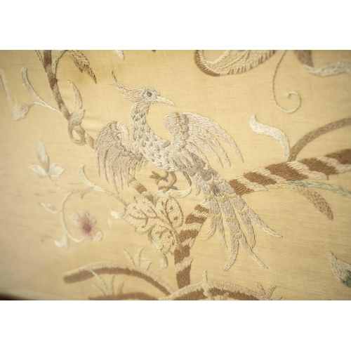 664 - An Edwardian walnut wide fire screen. The embroidered panel with two exotic birds, and foliage, heig... 