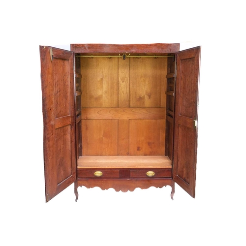 666 - An early 20th century French fruit wood wardrobe. With twin doors enclosing hanging space and two sh... 