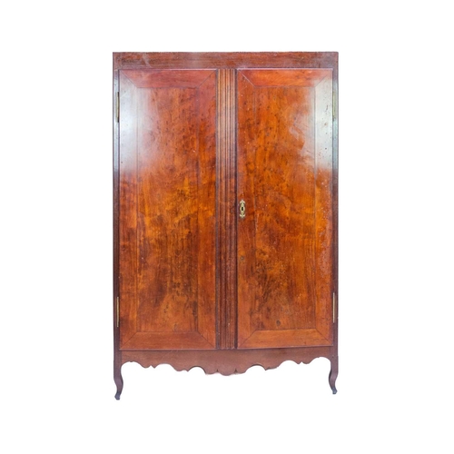 666 - An early 20th century French fruit wood wardrobe. With twin doors enclosing hanging space and two sh... 