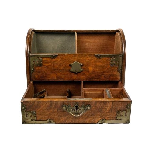 71 - An Edwardian oak dome top smokers compendium. With plated mounts, the drawer opens to reveal two com... 