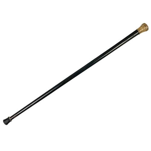 87 - A Victorian ebonised walking cane. The gilt metal terminal with repousse decoration and a snake, the... 