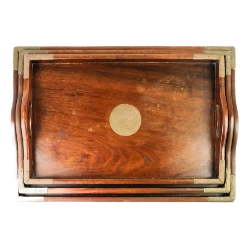 90 - A set of three graduated Chinese hardwood and brass trays. The largest 50.5cm x 35.5cm.