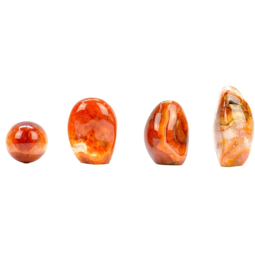 91 - Four polished mineral specimens. To include a polished banded agate mineral specimen, two Carnelian ... 