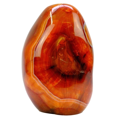 91 - Four polished mineral specimens. To include a polished banded agate mineral specimen, two Carnelian ... 