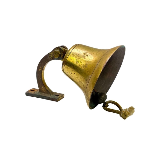 95 - A hanging brass bell. Height 13cm, together with a pair of Victorian brass candlesticks, a twin hand... 