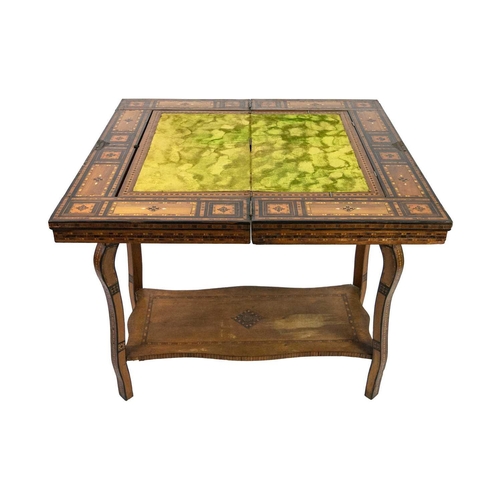 103 - A Syrian inlaid parquetry games table, 19th century. The swivel fold over top with a folding baize l... 