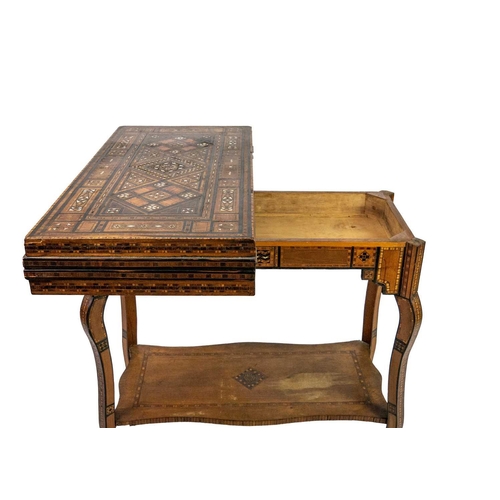 103 - A Syrian inlaid parquetry games table, 19th century. The swivel fold over top with a folding baize l... 