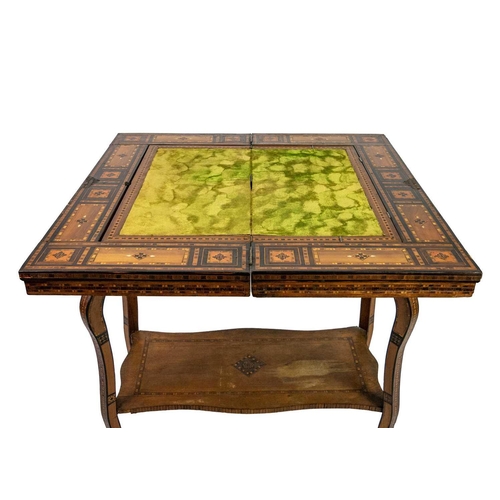 103 - A Syrian inlaid parquetry games table, 19th century. The swivel fold over top with a folding baize l... 