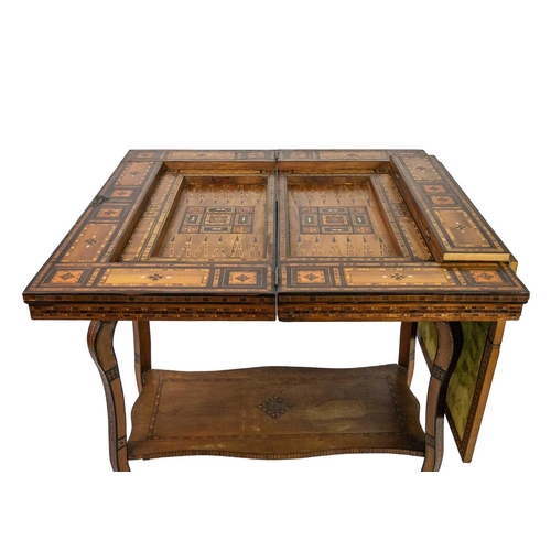 103 - A Syrian inlaid parquetry games table, 19th century. The swivel fold over top with a folding baize l... 