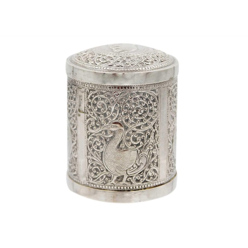 112 - An Indian silver cannister, early 20th century. The cover repousse decorated with an elphant within ... 