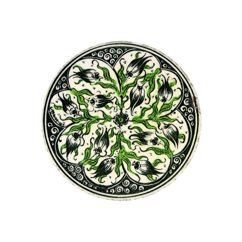 116 - A Middle Eastern circular porcelain tile, late 19th/early 20th century. With floral decoration, diam... 