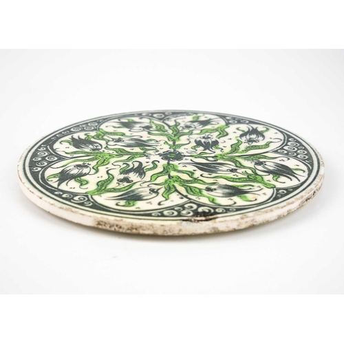 116 - A Middle Eastern circular porcelain tile, late 19th/early 20th century. With floral decoration, diam... 