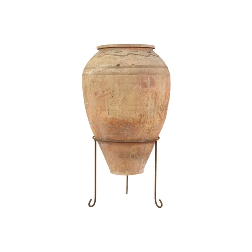 117 - A terracotta olive jar on metal stand. Height 70cm, width 37cm.