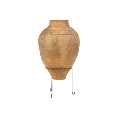 119 - A terracotta olive jar on metal stand. Height 81cm, width 39cm.