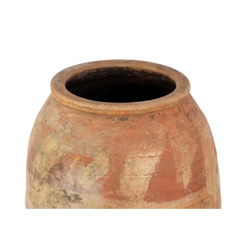 120 - A terracotta olive jar on metal stand. Height 82cm, width 32cm.