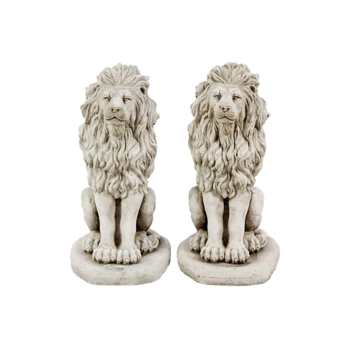 125 - A pair of reconstituted stone garden ornaments in the form of lions. Height 41cm, width 20cm, depth ... 