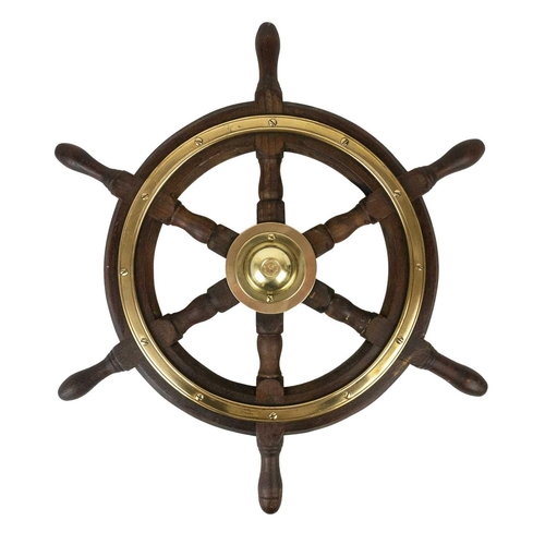 14 - A six spoke teak and brass bound yacht wheel by Simpson Lawrence. Diameter 53cm.