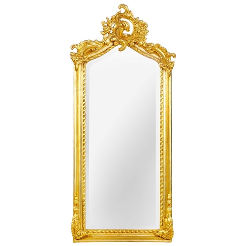 243 - A gilt composition wall mirror, 20th century. 113 x 50cm.