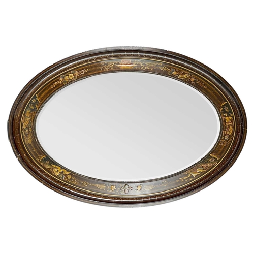 249 - An Edwardian Chinoiserie lacquered oval wall mirror. 85cmx 58cm.