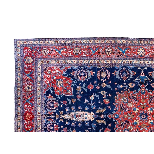 257 - A Tabriz carpet, North West Persia, circa 1920. With signature cartouche, the indigo field with a ce... 