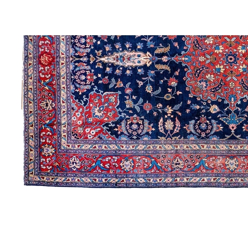 257 - A Tabriz carpet, North West Persia, circa 1920. With signature cartouche, the indigo field with a ce... 