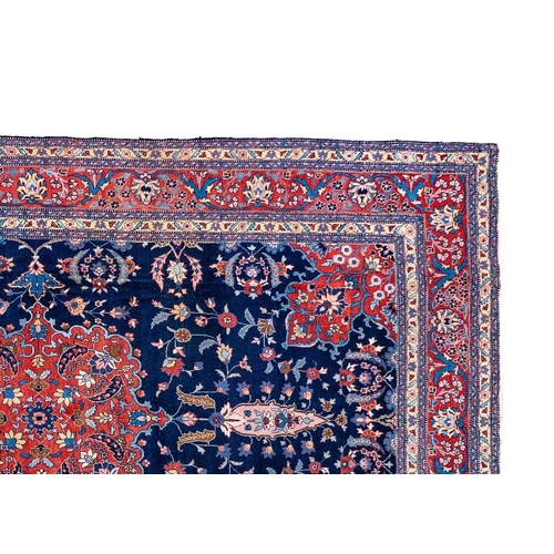 257 - A Tabriz carpet, North West Persia, circa 1920. With signature cartouche, the indigo field with a ce... 