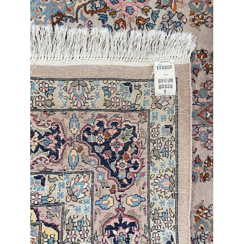 266 - A North West Persian rug. With a central polychrome floral medallion, within three borders, 223 x 14... 