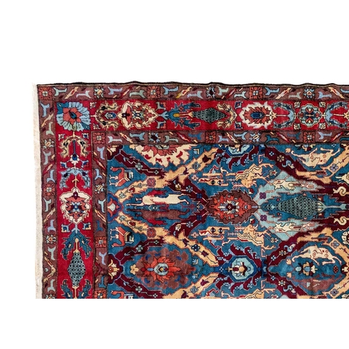 273 - A Tabriz carpet, North West Persia, circa 1930/40's. The blue field with polychrome trellis design a... 