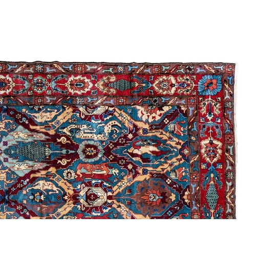 273 - A Tabriz carpet, North West Persia, circa 1930/40's. The blue field with polychrome trellis design a... 