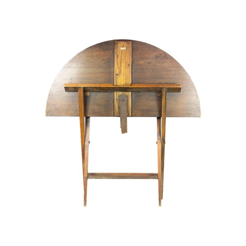 287 - A mahogany folding campaign table, early 20th century. The circular top on square tapering legs, wit... 