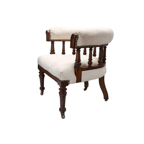 289 - A Victorian upholstered oak frame tub chair. The bow back above turned spindles on ceramic castor wh... 