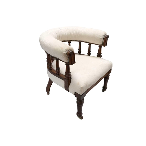 289 - A Victorian upholstered oak frame tub chair. The bow back above turned spindles on ceramic castor wh... 