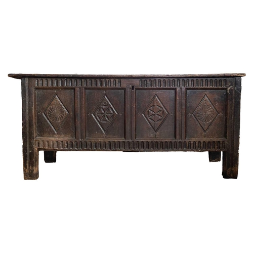 291 - A 17th century carved oak coffer. With a quadruple panelled front on stile feet, height 73cm, width ... 