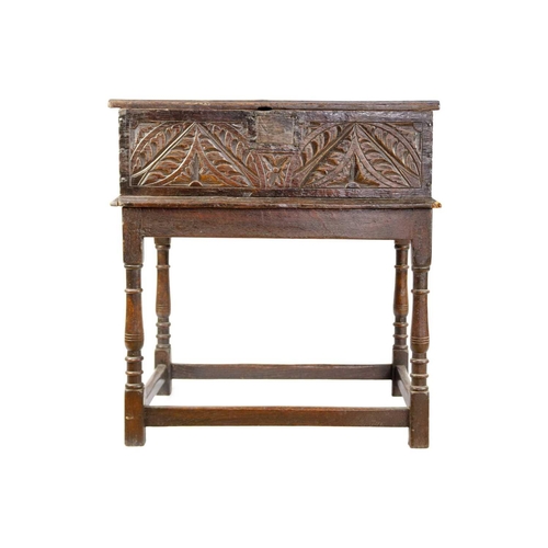 293 - A 17th century carved oak bible box. On associated stand, height 21.5cm, width 99cm, depth 42cm.