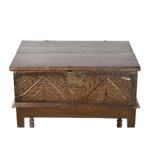 293 - A 17th century carved oak bible box. On associated stand, height 21.5cm, width 99cm, depth 42cm.