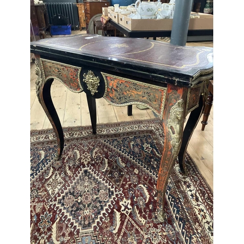 309 - A French Boulle fold over serpentine card table, 19th century. In the Louis XV style, with leather i... 