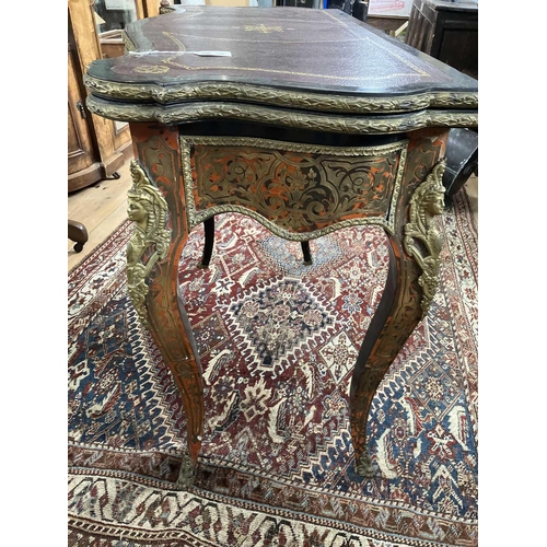 309 - A French Boulle fold over serpentine card table, 19th century. In the Louis XV style, with leather i... 