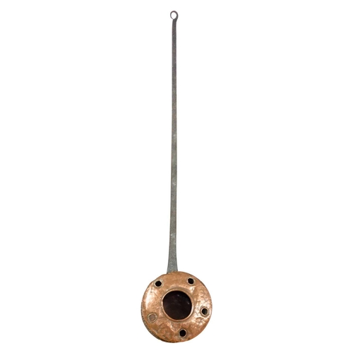 31 - An 18th century copper warming pan. With iron handle, length 121cm, width 26cm.