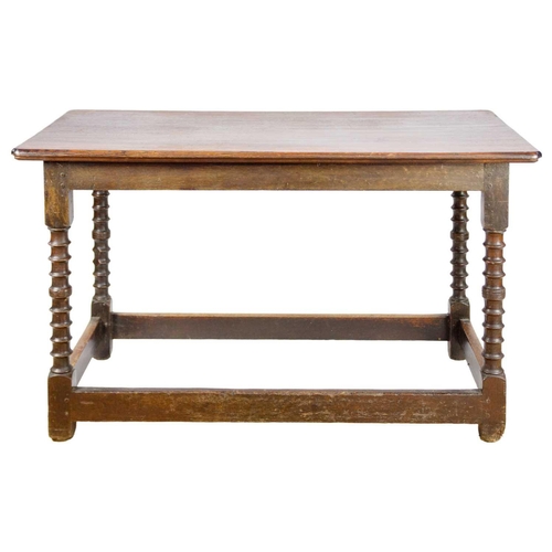 310 - An 18th/19th century oak side table. The rectangular top on ring turned supports joined by stretcher... 