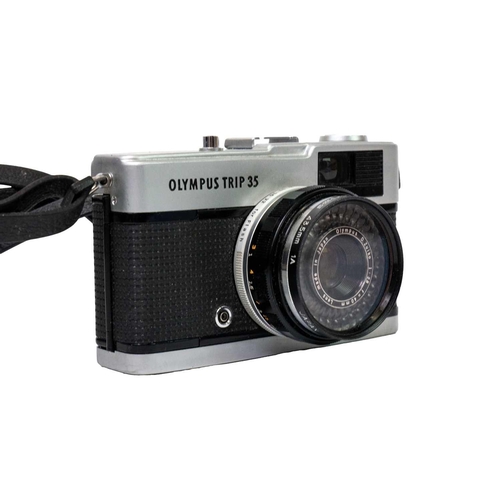 32 - An Olympus OM10 SLR camera. Fitted with a Sigma Zoom Master 35-70mm lens and other accessories toget... 