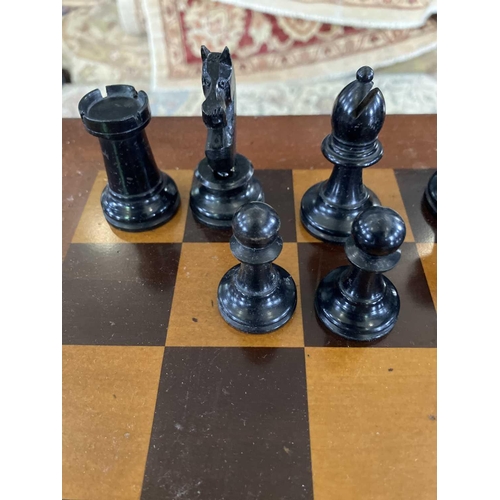 37 - A Staunton pattern ebonised and boxwood chess set, and a small chess table. The unweighted set in or... 