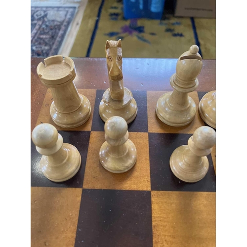 37 - A Staunton pattern ebonised and boxwood chess set, and a small chess table. The unweighted set in or... 