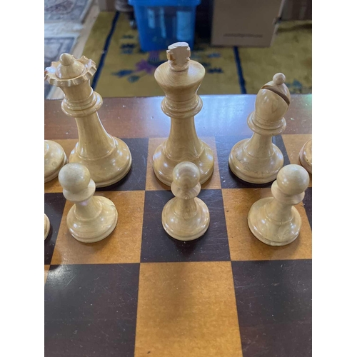 37 - A Staunton pattern ebonised and boxwood chess set, and a small chess table. The unweighted set in or... 