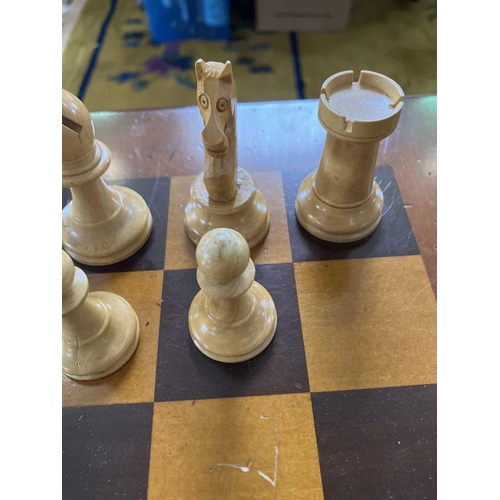 37 - A Staunton pattern ebonised and boxwood chess set, and a small chess table. The unweighted set in or... 