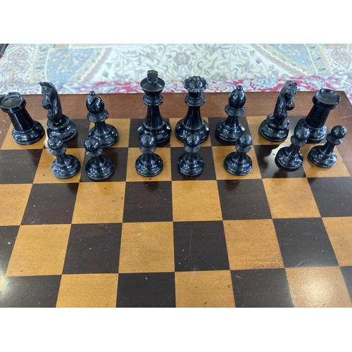 37 - A Staunton pattern ebonised and boxwood chess set, and a small chess table. The unweighted set in or... 