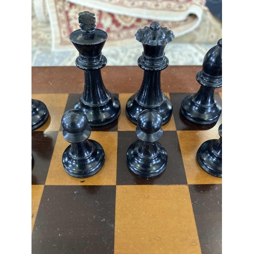 37 - A Staunton pattern ebonised and boxwood chess set, and a small chess table. The unweighted set in or... 